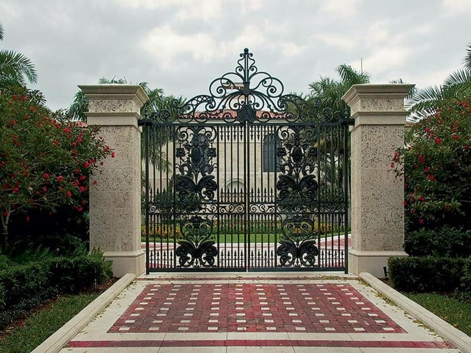 Ornate wrought iron entry gate at a Naples luxury home